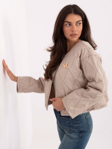 Beżowa damska kurtka z broszką